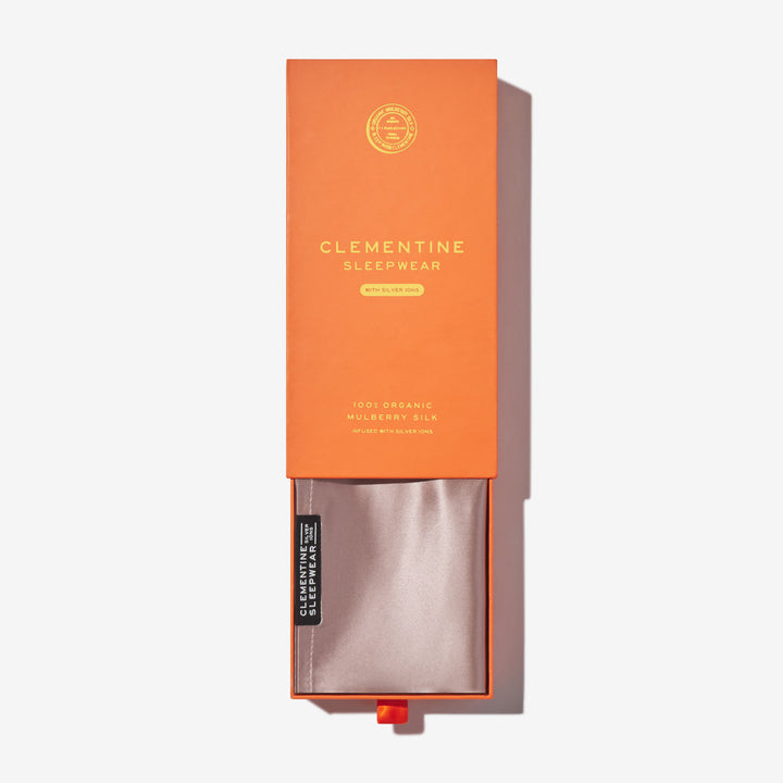 Orange box labeled CLEMENTINE SLEEPWEAR WITH SILVER IONS 100% ORGANIC MULBERRY SILK, silk pouch inside. - #color_rose-mist