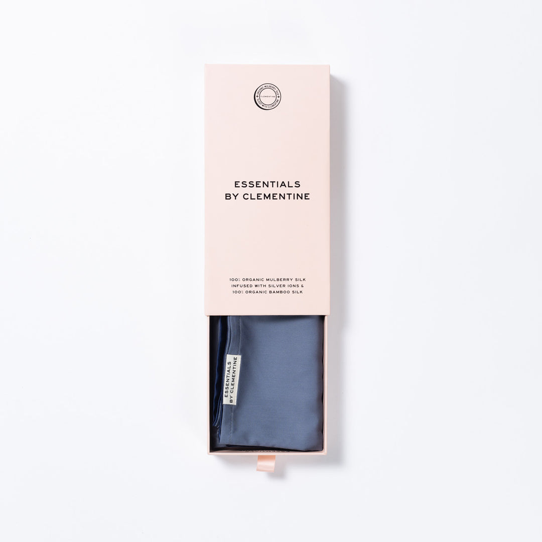 Folded blue-lagoon silk in pale pink box labeled 'ESSENTIALS BY CLEMENTINE' - #color_blue-lagoon