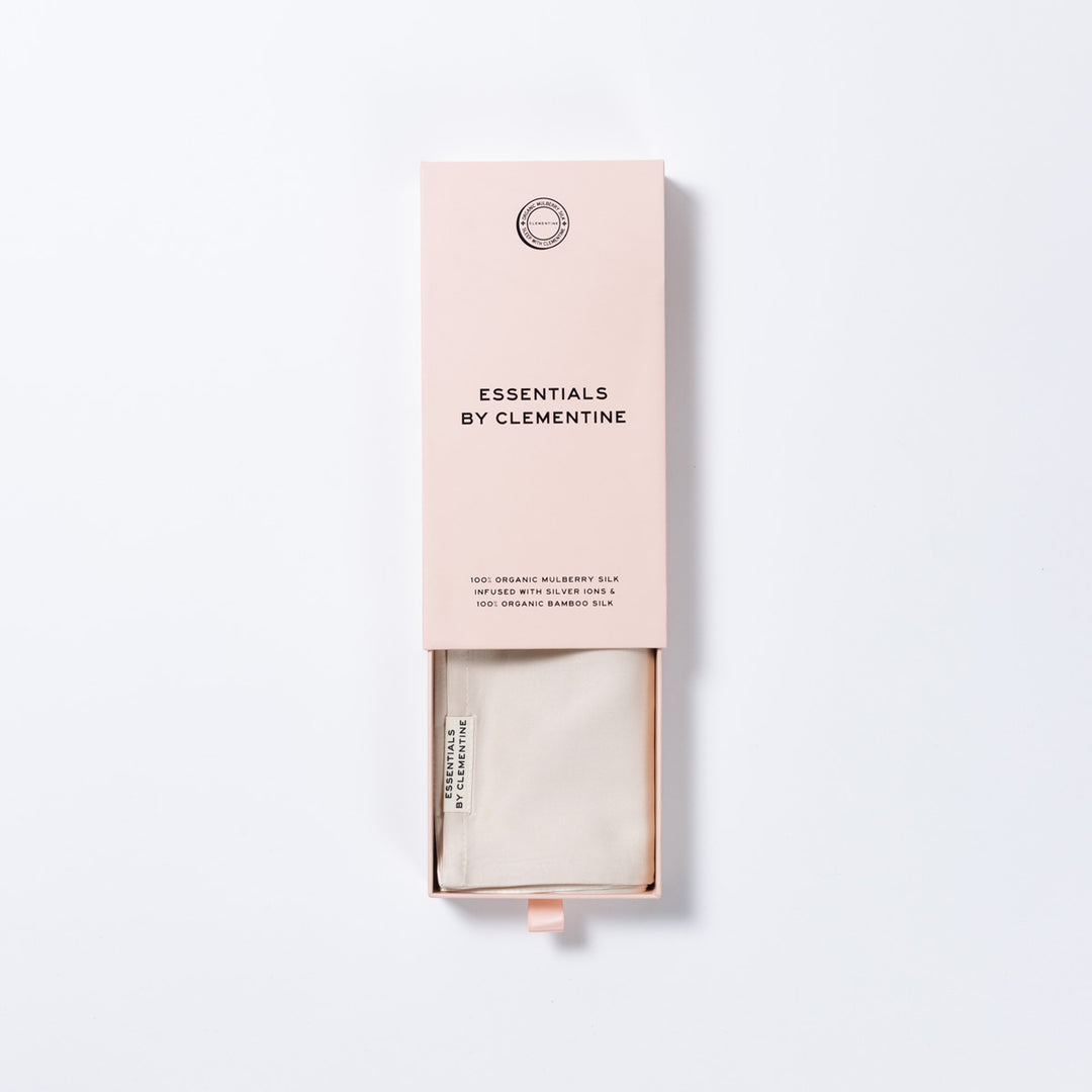 Pink sliding box with label 'ESSENTIALS BY CLEMENTINE' and folded champagne silk inside - #color_champagne-sunset