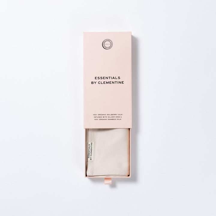 Pink sliding box with label 'ESSENTIALS BY CLEMENTINE' and folded champagne silk inside - #color_champagne-sunset