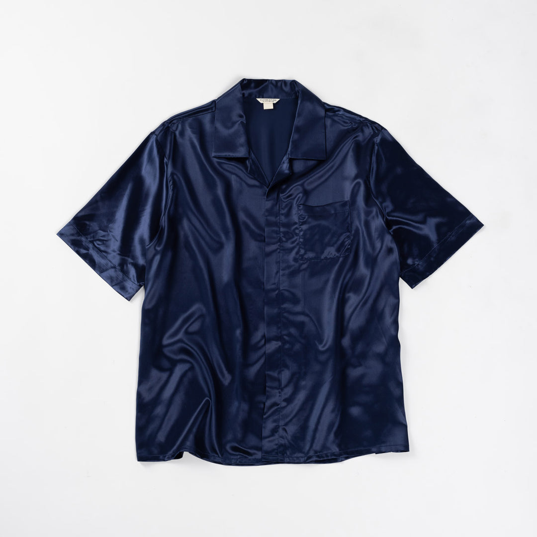 Navy blue silk short-sleeve shirt with a chest pocket, laid flat on a white background - #color_navy-blue