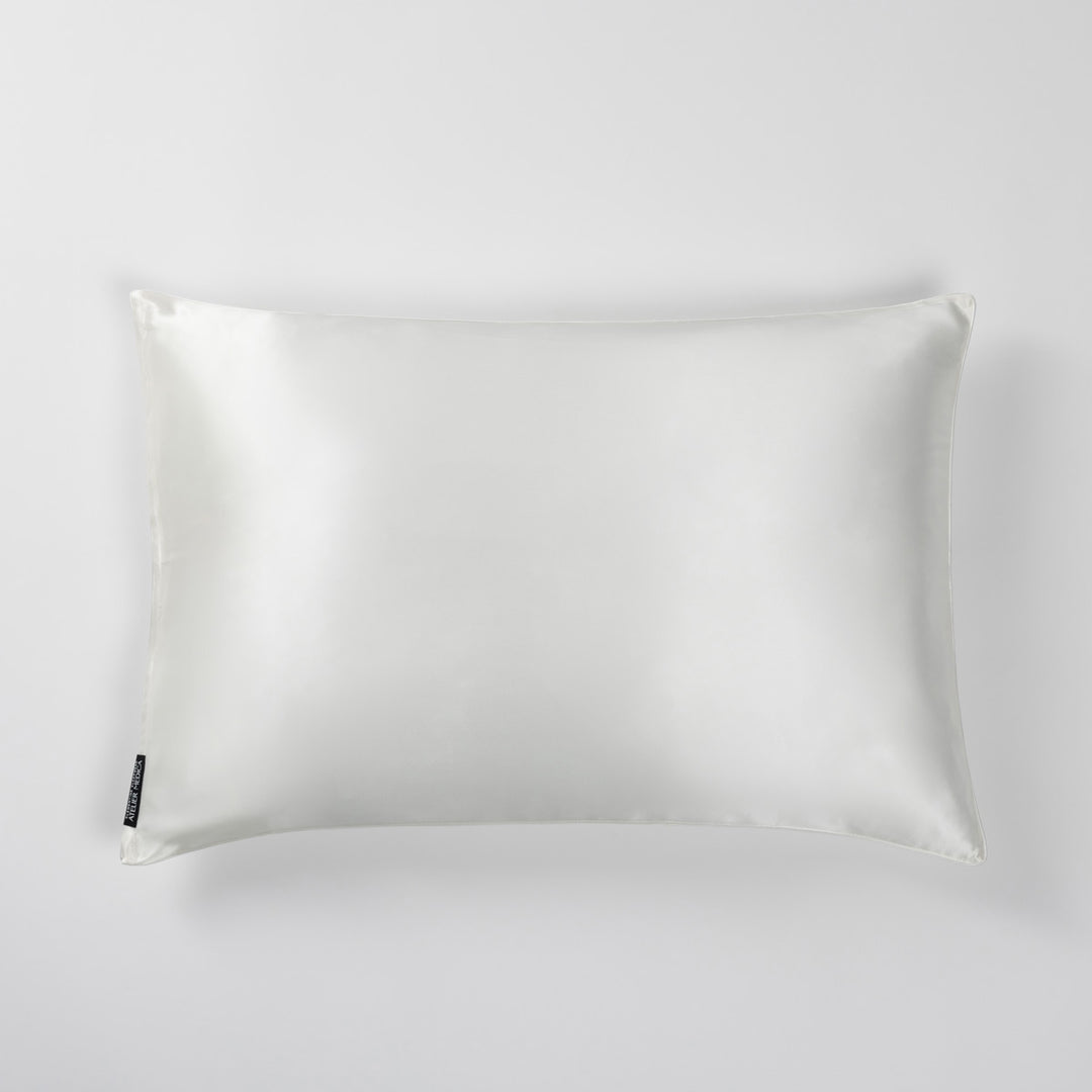 Pearl-white silk pillowcase, top view on light background - #color_pearl-white