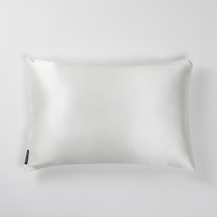Pearl-white silk pillowcase, top view on light background - #color_pearl-white