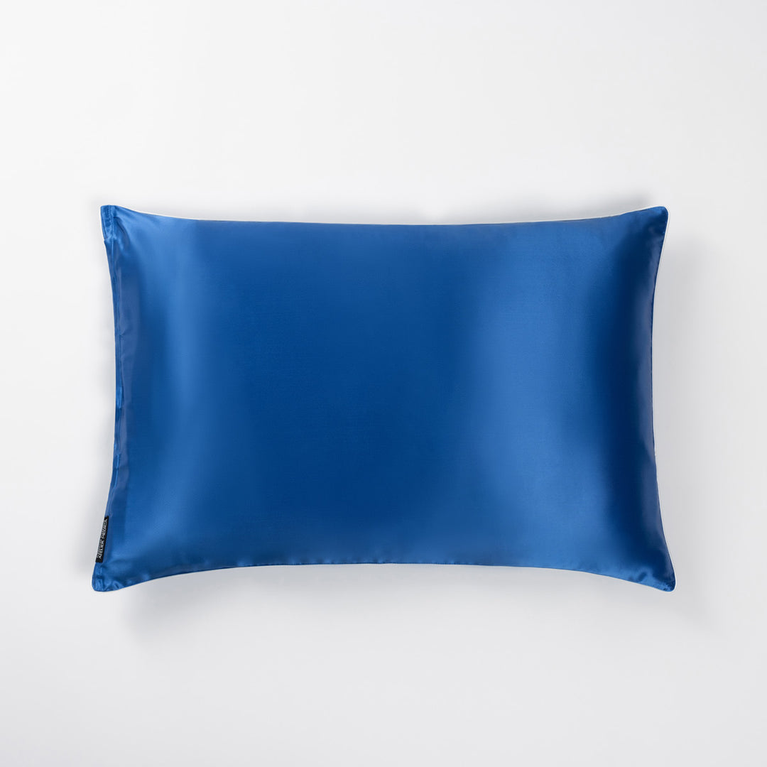 Ocean-blue silk pillowcase lying flat on white background. - #color_ocean