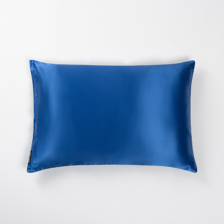 Ocean-blue silk pillowcase lying flat on white background. - #color_ocean