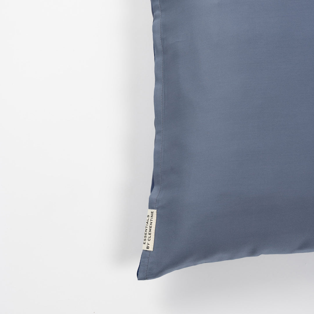 Blue-lagoon pillowcase corner with fabric tag reading ESSENTIALS BY CLEMENTINE - #color_blue-lagoon