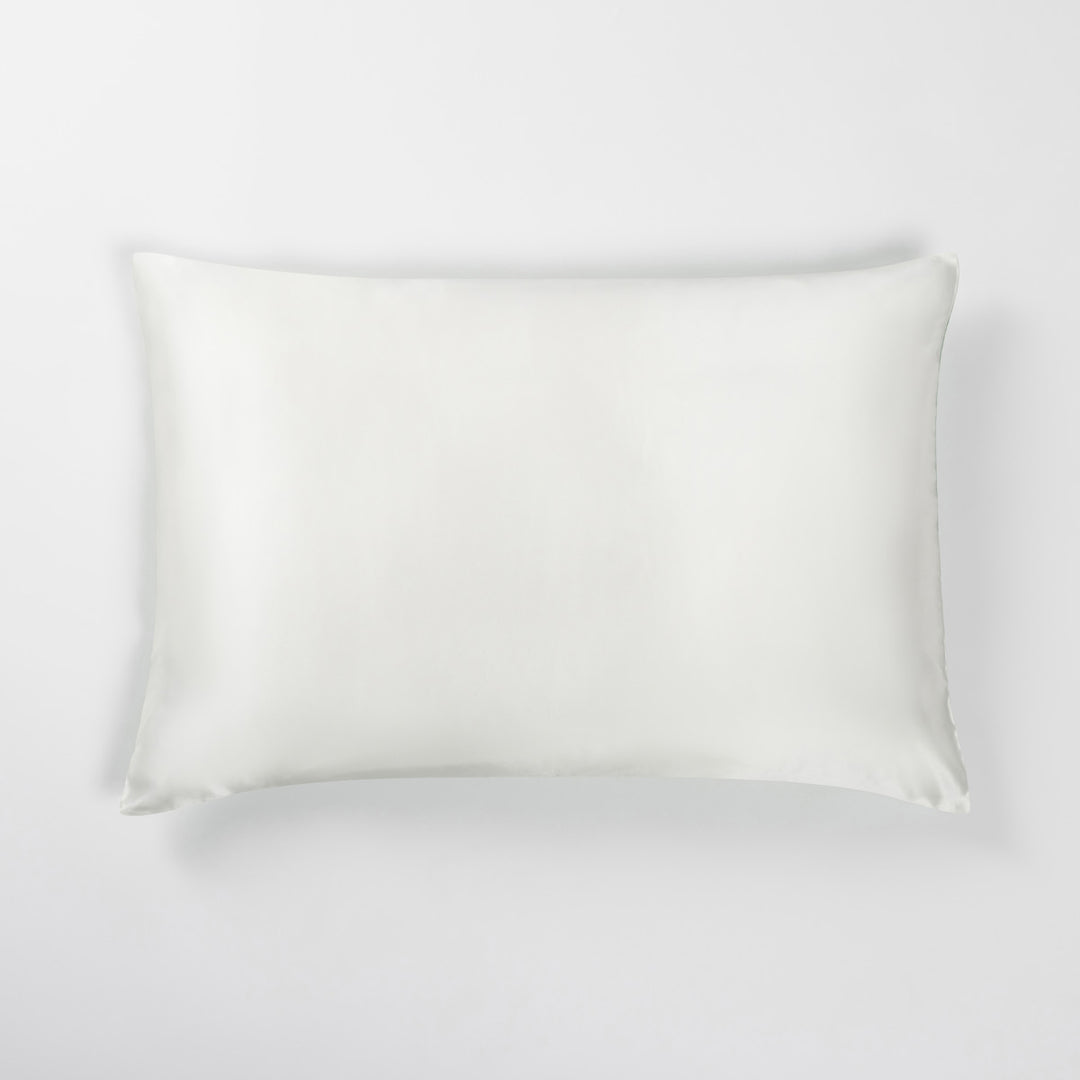 White rectangular pillow with stitched edges on a light neutral background - #color_match-point-green