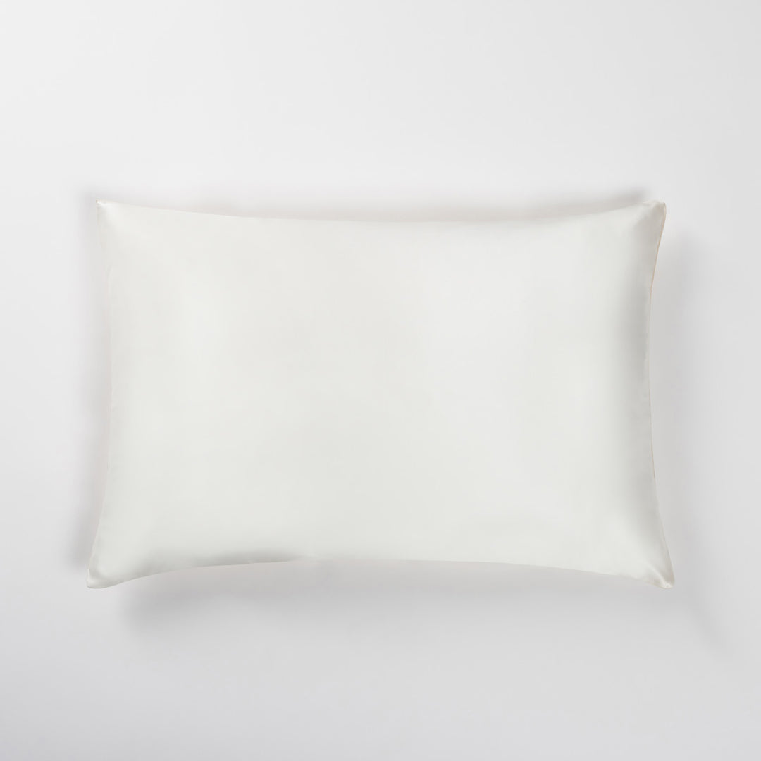 champagne silk pillowcase laid flat on a light background - #color_champagne-sunset