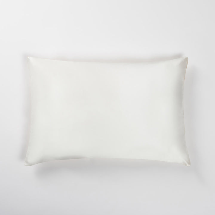 champagne silk pillowcase laid flat on a light background - #color_champagne-sunset