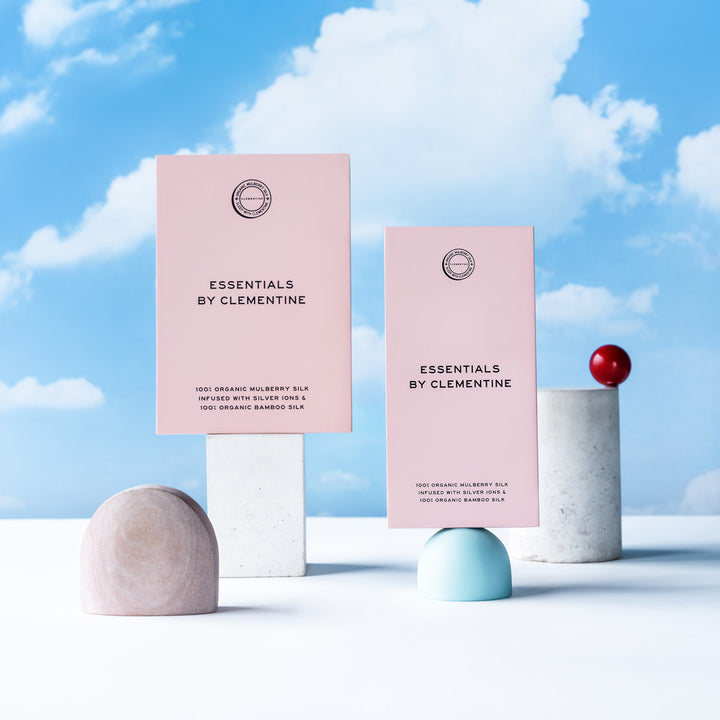 Pink boxes; text: ESSENTIALS BY CLEMENTINE 100% ORGANIC MULBERRY SILK INFUSED WITH SILVER IONS & 100% ORGANIC BAMBOO SILK - #color_ballet-pink