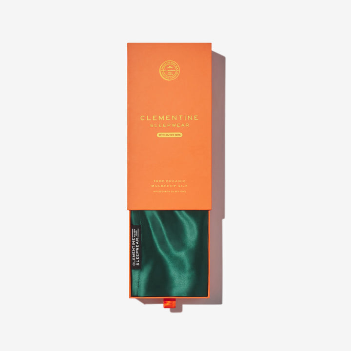 Green silk pillowcase in orange box labeled CLEMENTINE SLEEPWEAR WITH SILVER IONS 100% ORGANIC MULBERRY SILK - Pillowcase green in box#color_forest-green