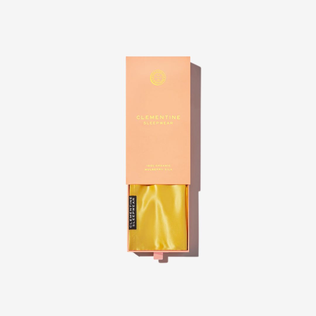 Lemon silk pillowcase inside peach box labeled 'CLEMENTINE SLEEPWEAR' and '100% ORGANIC MULBERRY SILK'. - pillowcase in box#color_lemon