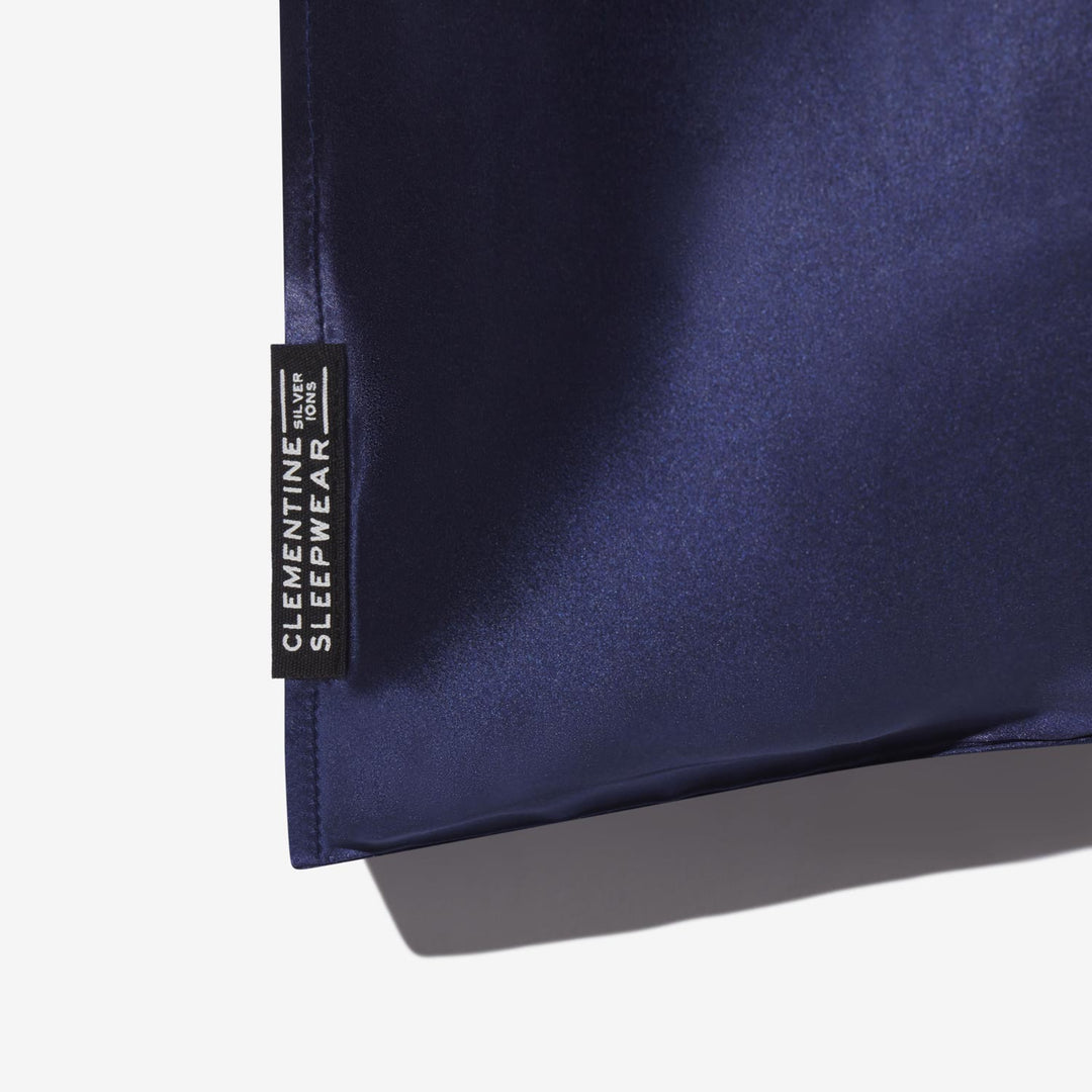 Navy blue fabric with a label reading 'CLEMENTINE SLEEPWEAR SILVER IONS' - #color_navy-blue