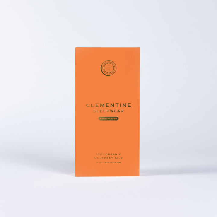 Orange packaging panel reading 'CLEMENTINE SLEEPWEAR' with 'WITH SILVER IONS' and '100% ORGANIC MULBERRY SILK'. - #color_navy-blue