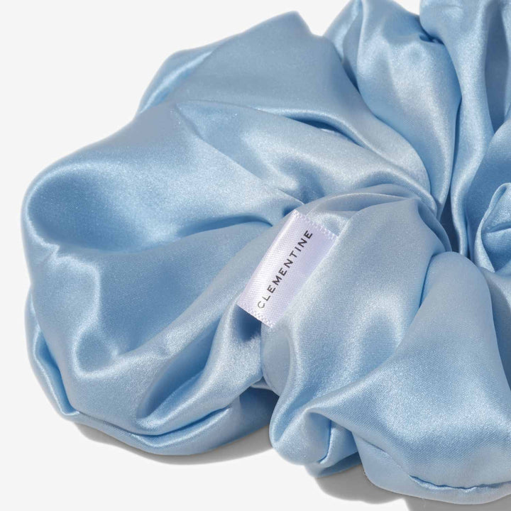 Sky-blue silk scrunchie with label reading CLEMENTINE