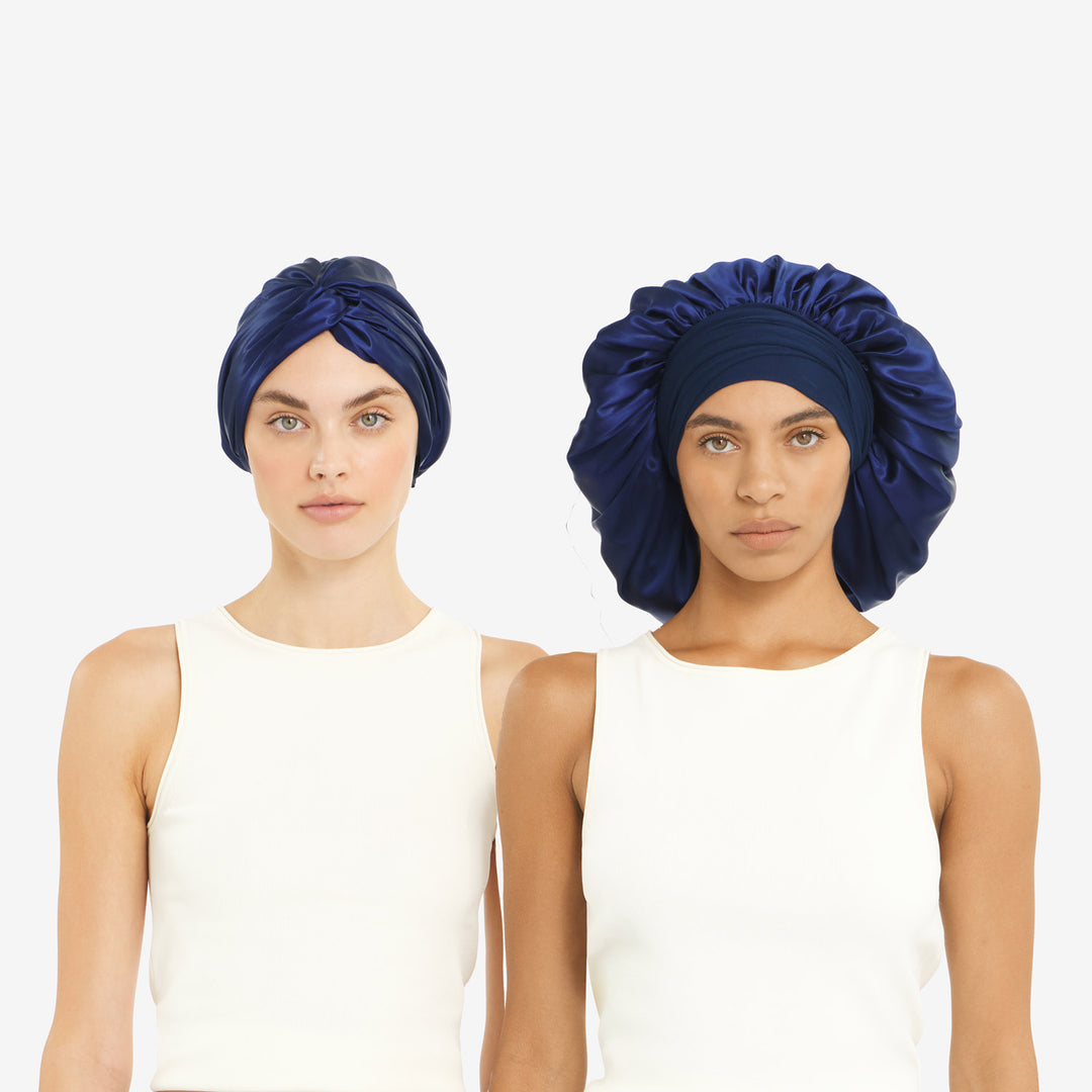 Two models wearing navy silk bonnets—left fitted turban, right oversized XL bonnet