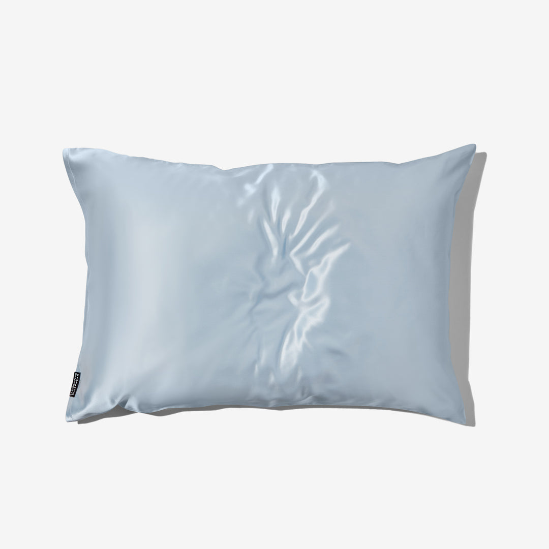 Sky-blue organic silk pillowcase with subtle sheen, flat on white background - organic silk pillowcase blue#color_sky-blue