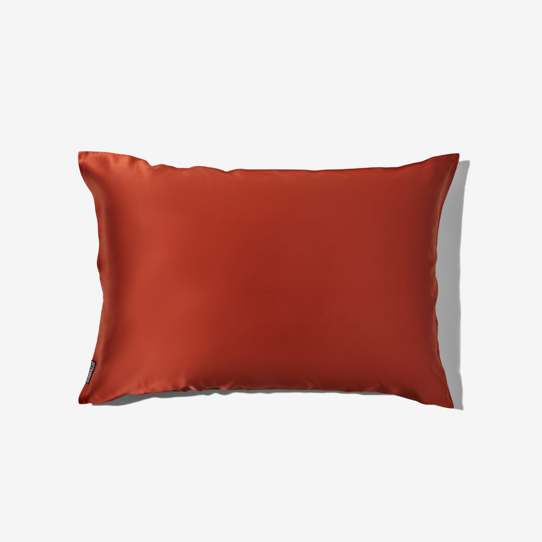 Dusk-colored luxury silk pillowcase laid flat on white background - #color_dusk