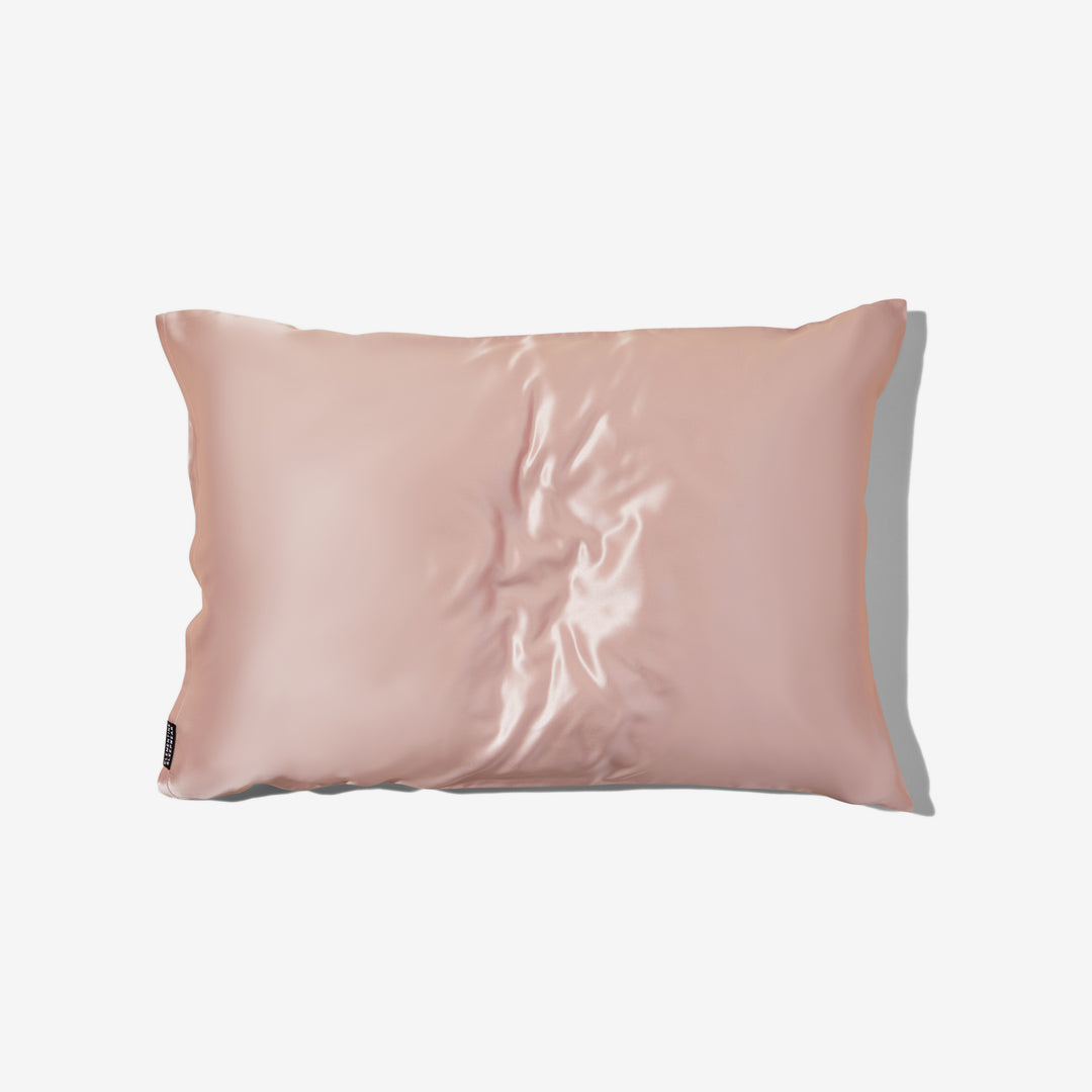 rectangular pink organic silk pillowcase with slight sheen on cream background#color_pink-sherbert