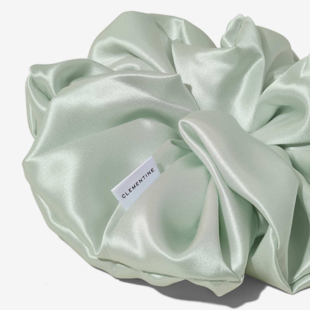 Mint silk hair scrunchie with visible CLEMENTINE fabric tag