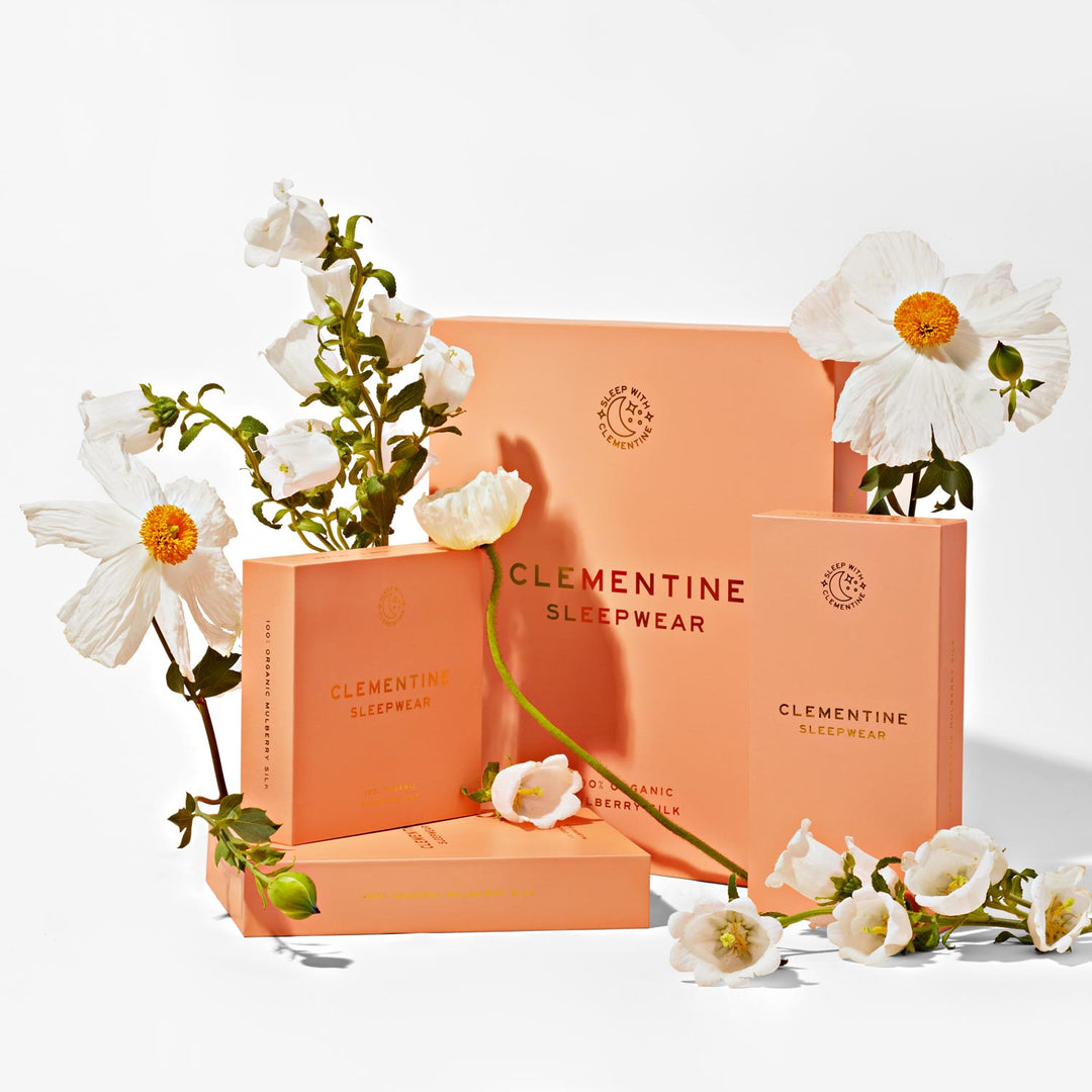 Peach packaging with white flowers and the words: CLEMENTINE SLEEPWEAR; SLEEP WITH CLEMENTINE; 100% ORGANIC MULBERRY SILK