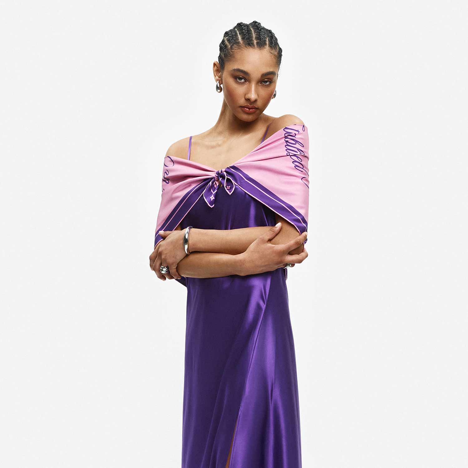 Front view of Lovers Scarf 90 draped on model showcasing 90 x 90 cm organic silk twill in purple with cursive text print on a white background #color_crush