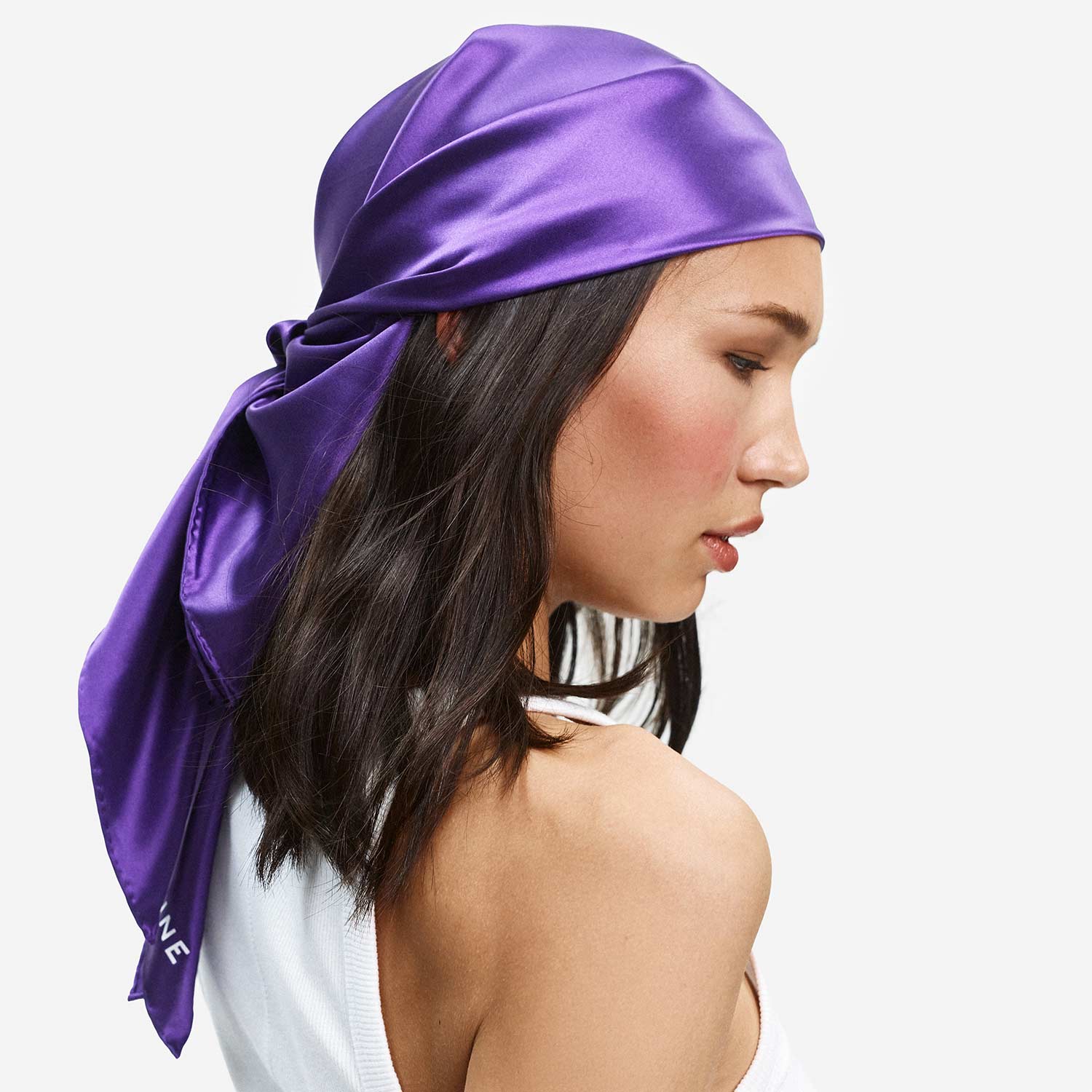 Three-quarter profile of Sleep Scarf Organic Silk in ultraviolet showcasing tied-back style and 22 momme silk drape on white #color_ultraviolet