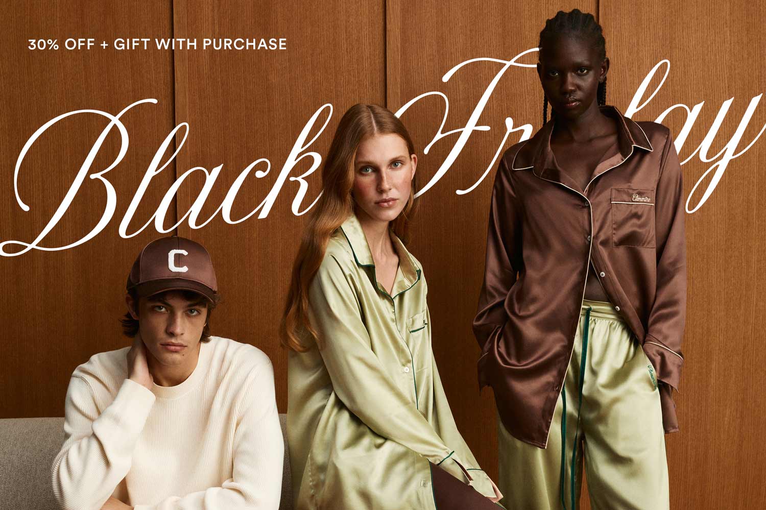Three models in silk sleepwear against wood panels with text '30% OFF + GIFT WITH PURCHASE' and 'Black Friday'