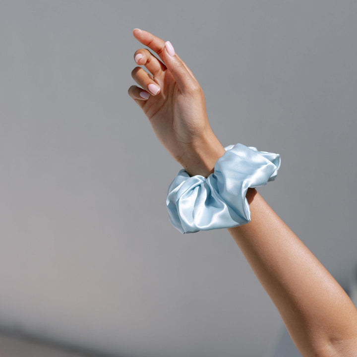 Organic blue silk on arm in scrunchie#color_sky-blue