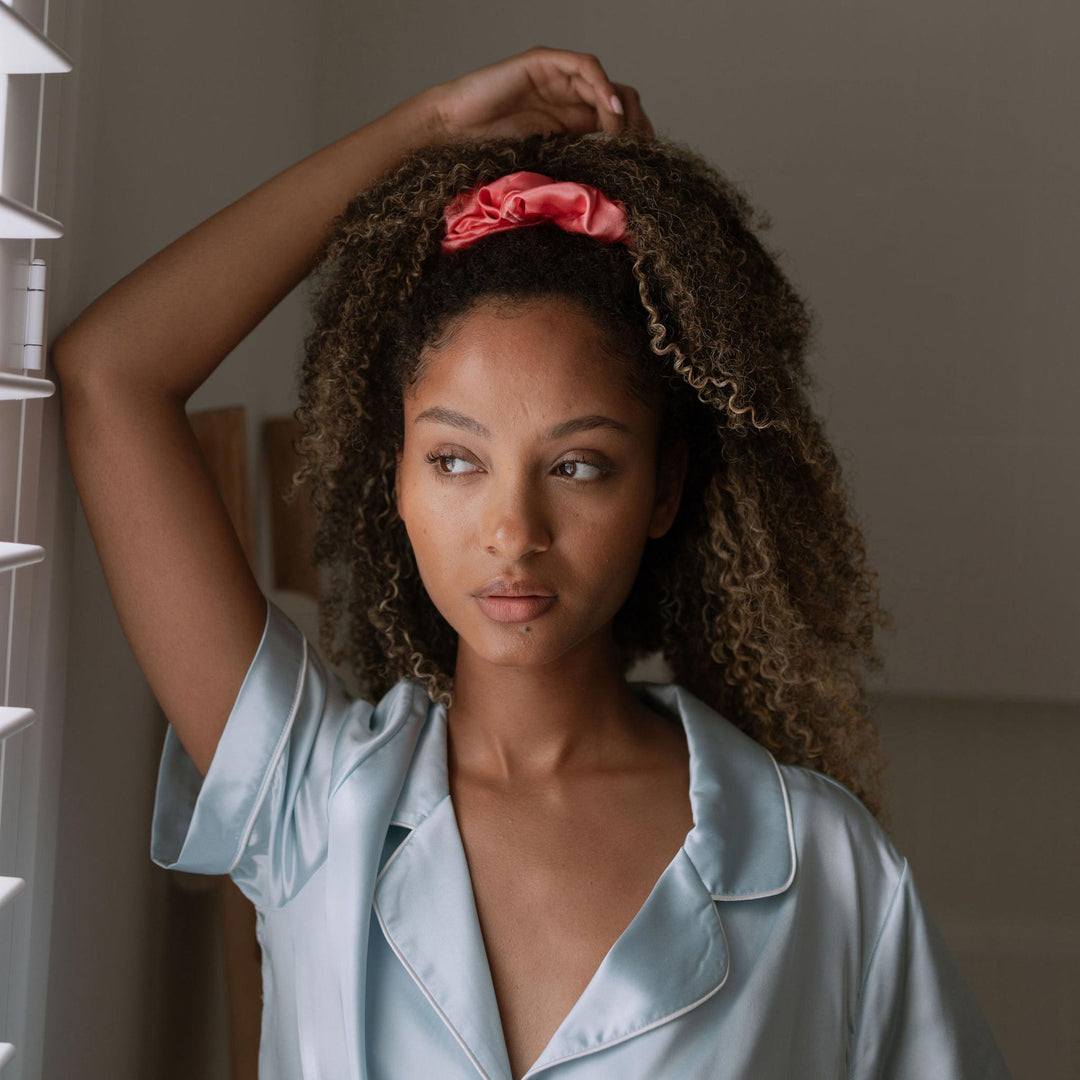 By window in light with pink blush organic silk scrunchie on#color_blush