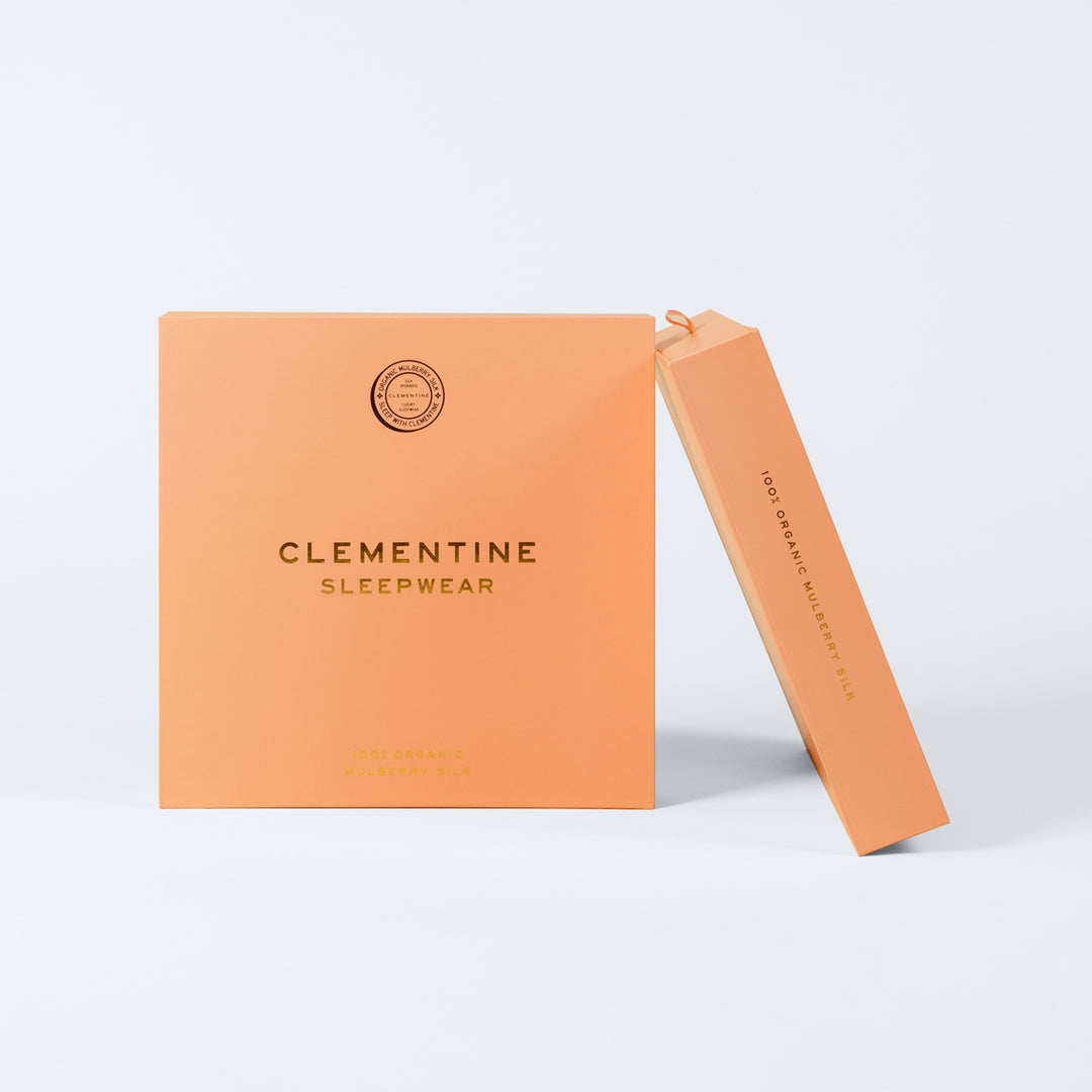 Orange packaging boxes for Clementine Sleepwear labeled CLEMENTINE SLEEPWEAR 100% ORGANIC MULBERRY SILK. - 