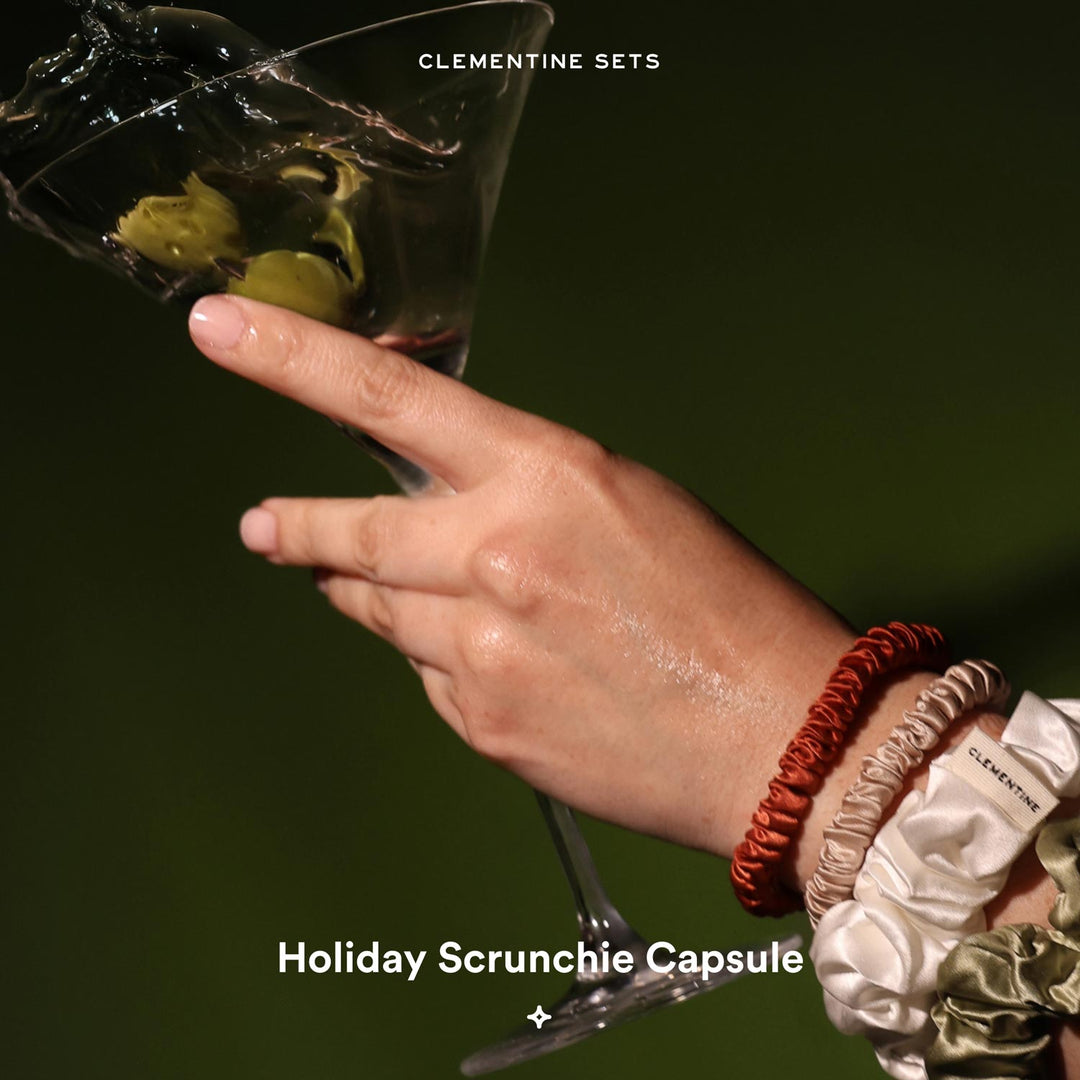 Hand holding martini glass with olives; wrist wearing scrunchies — CLEMENTINE SETS; Holiday Scrunchie Capsule