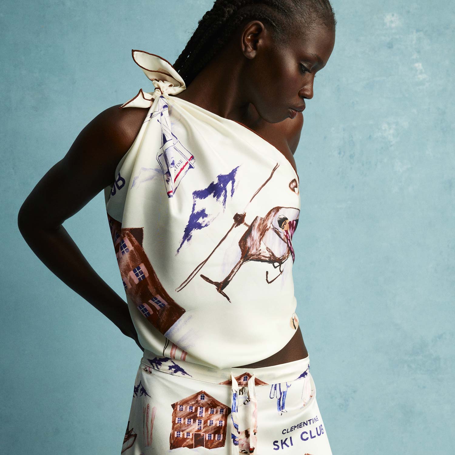 Cream silk scarf tied as a one-shoulder top with skiers and chalets, printed text CLEMENTINE SKI CLUB.