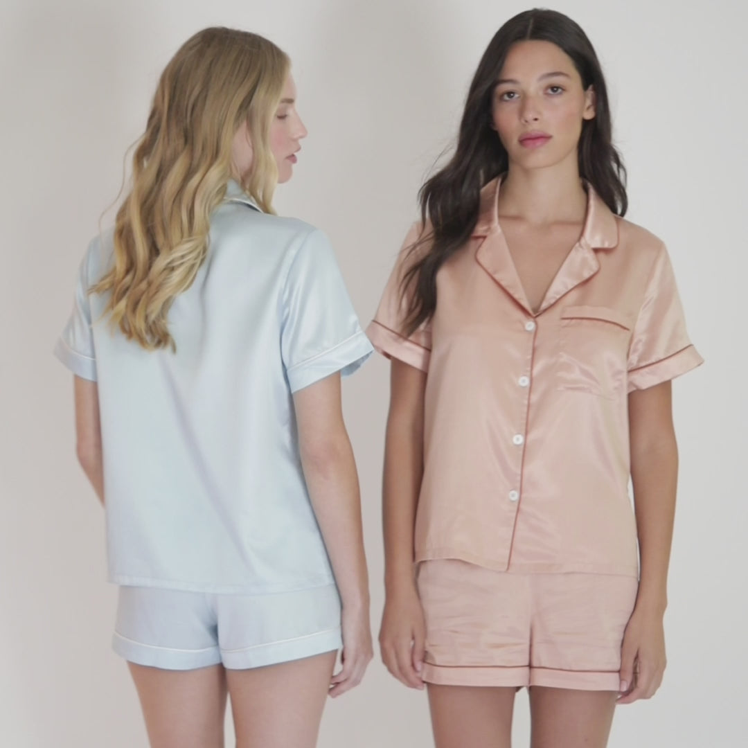 Women wearing peach and blue and white organic silk pajamas#color_clementine-peach-and-dusk