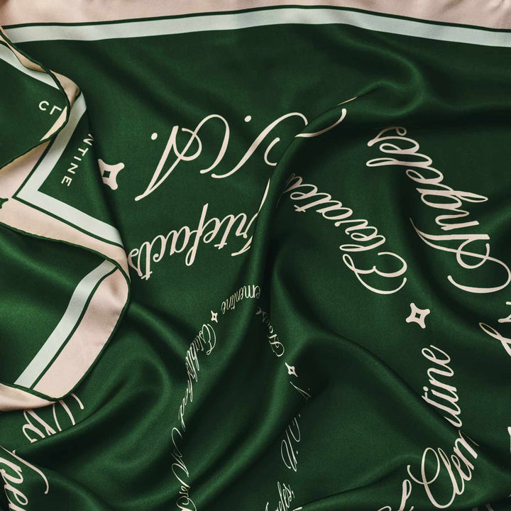 Green scarf with text and a logo on it in clementine design. #color_palais-green