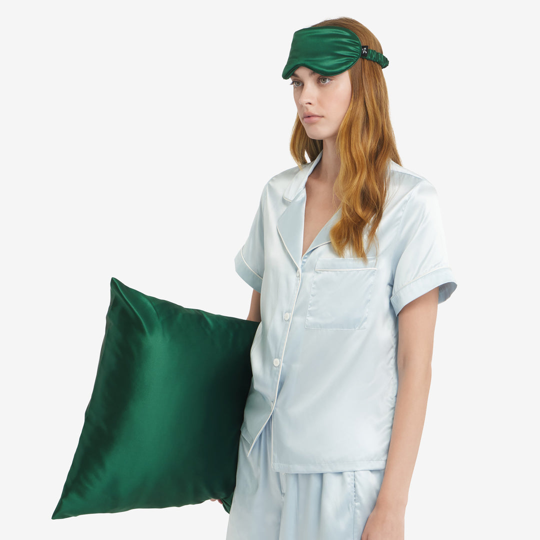 Holding pillow on side#color_forest-green